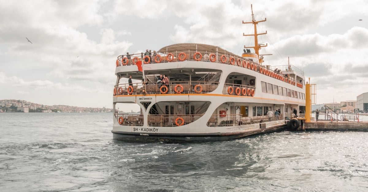 A public Şehir Hatları ferry crossing the Bosphorus past waterside mansions in Istanbul