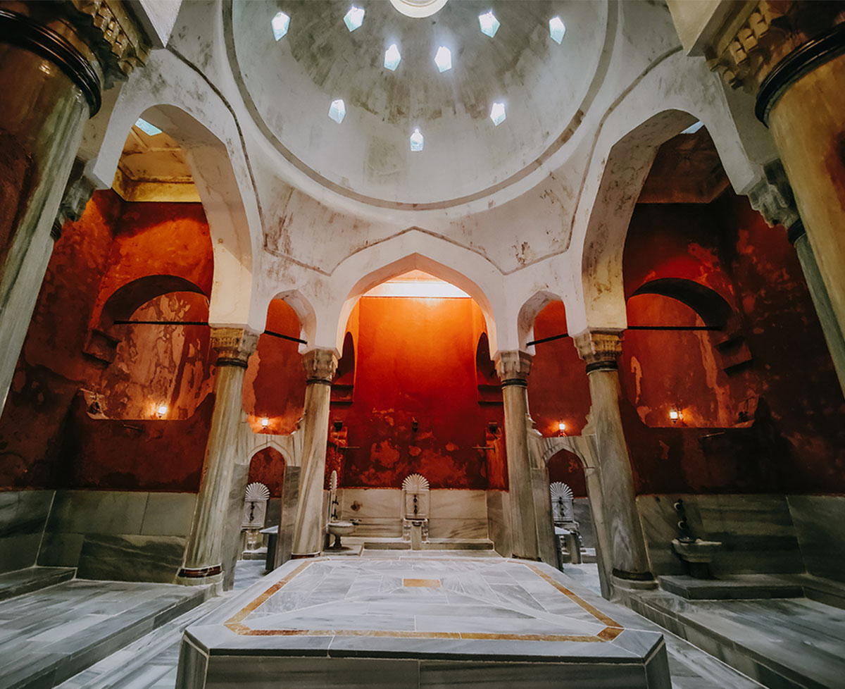 Heated marble platform under a domed ceiling inside an Istanbul hammam hot room