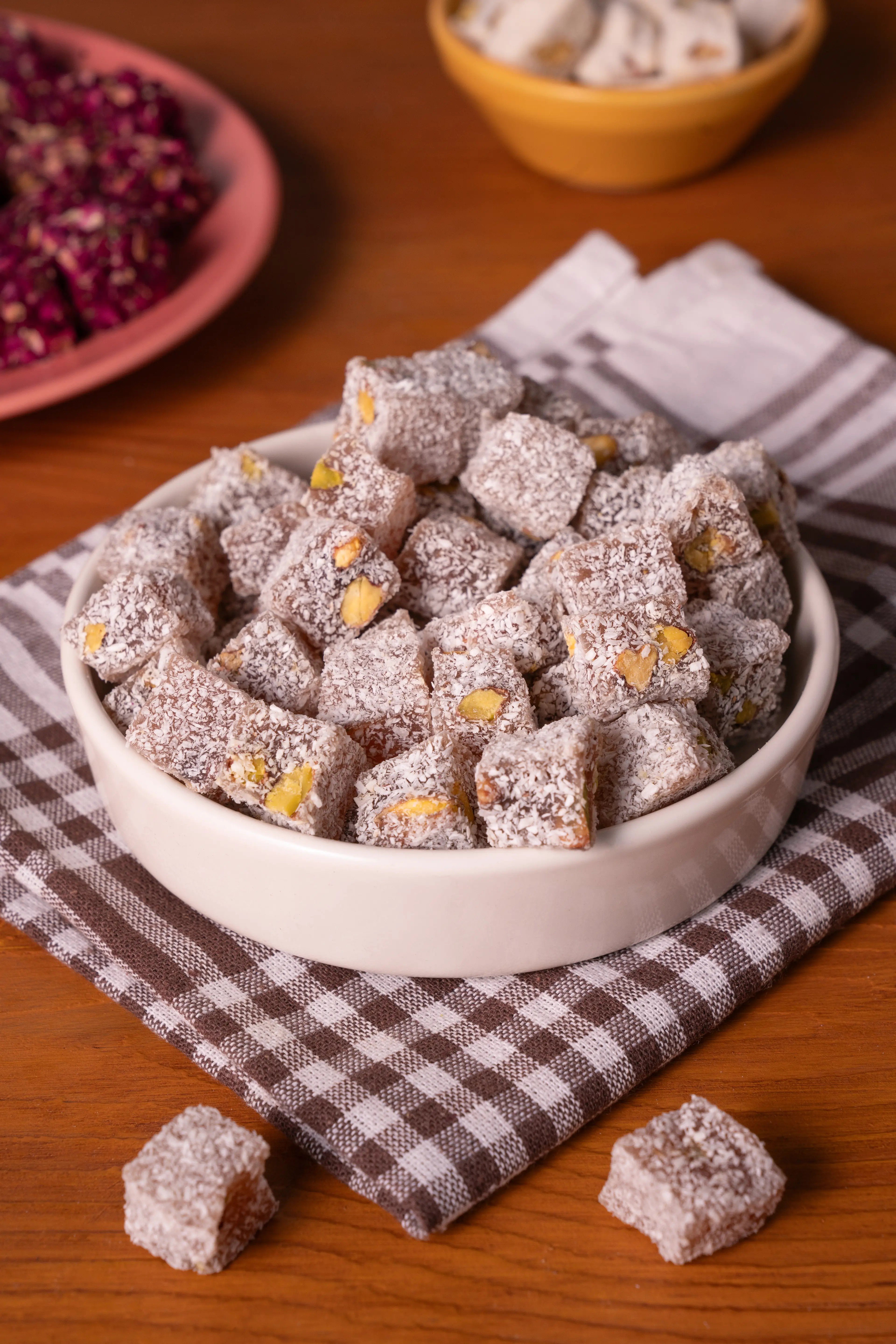 Pistachio, rose, and fruit-flavored Turkish delight (lokum) stacked in a confectionery display
